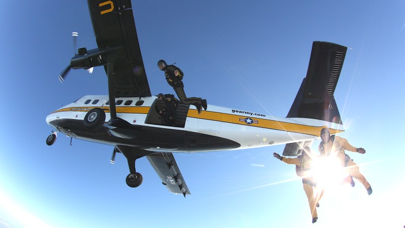 Members of the US Army's Golden Knights parachute demonstration team jump from a UV-18 Twin Otter aircraft.
