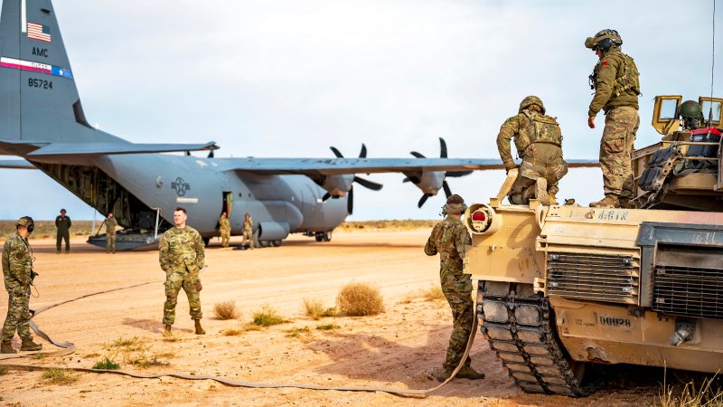 Army and Air Force team up to simulate hot pit refueling an M1A2 Abrams tank with a C-130J Super Hercules