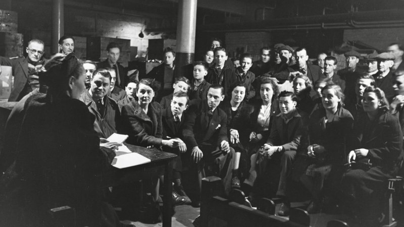 People listen to the speaker at a Discussion Circle in an air raid shelter in Bermondsey in 1940.