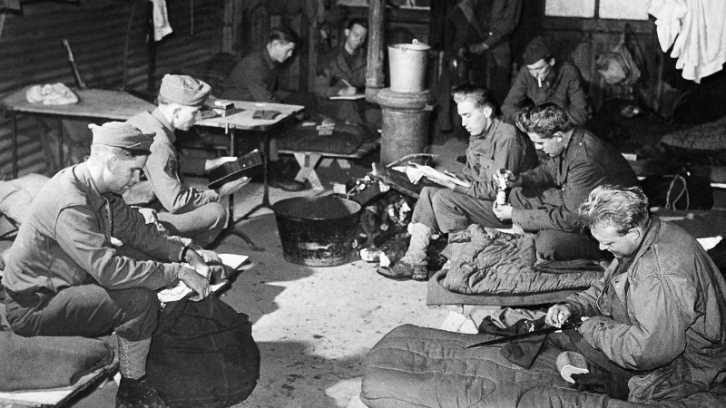 Soldiers pass the time reading while in their shelter