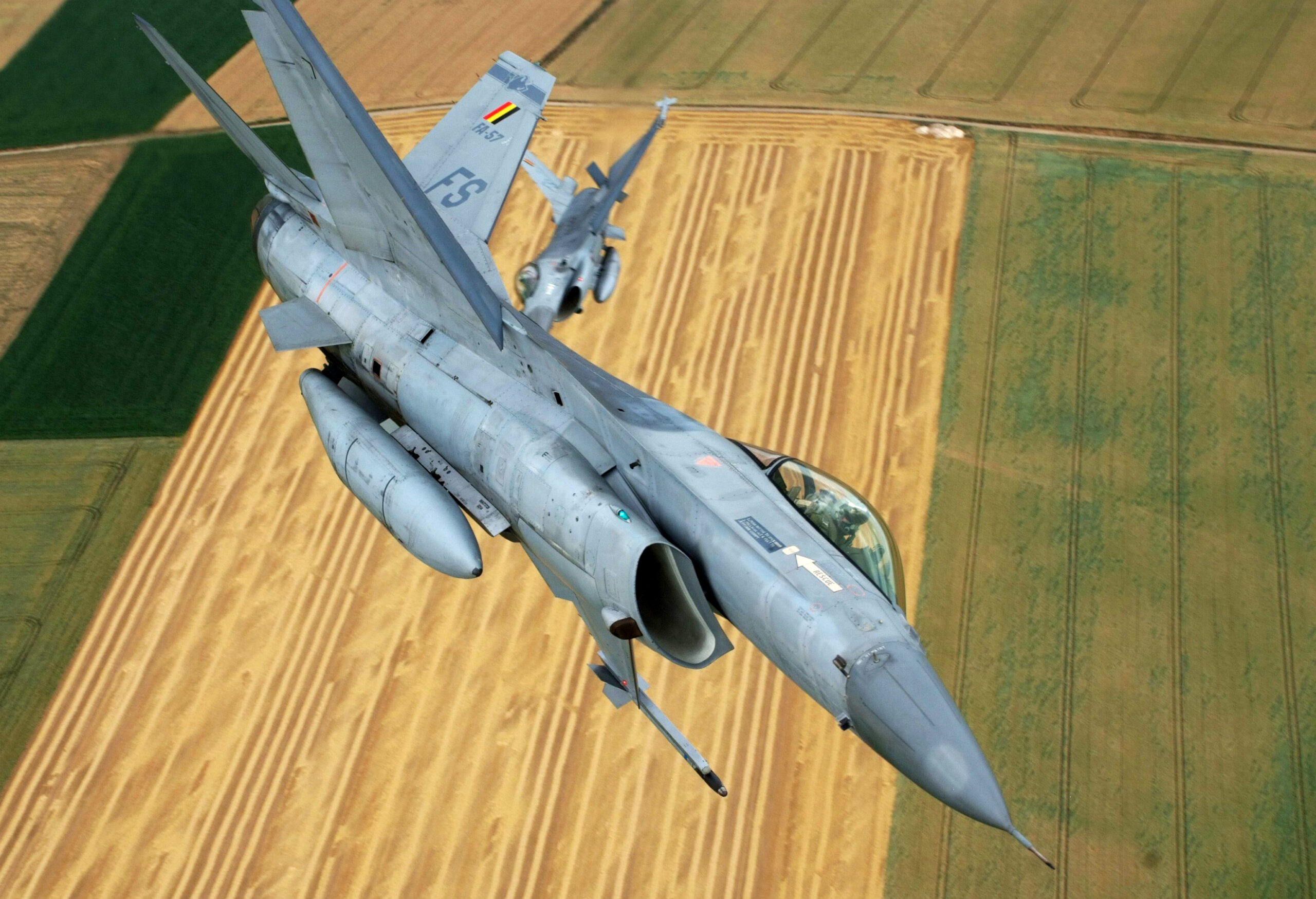 A file picture taken on July 16, 2010 shows two Belgian air force's F-16 fighter jets during a rehearsal flight for the national parade in Florennes. Belgium is ready to take part in military action in Libya under a NATO umbrella with six F-16 and a frigate, European Affairs Minister Olivier Chastel said on March 18, 2011.