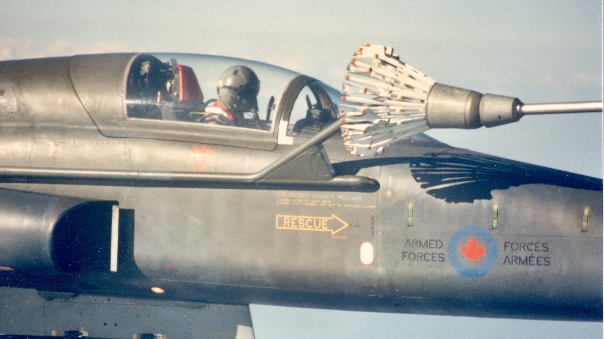 A solo student plugged in to the tanker. Note how large the solid steel basket is, and how close it is to the delicate fighter