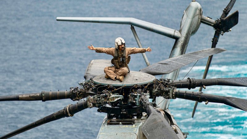 U.S. Marine Corps Sgt. Brandon CarmonaTadeo, a CH-53E Super Stallion crew chief assigned to Marine Medium Tiltrotor Squadron (VMM) 165 (Reinforced), 15th Marine Expeditionary Unit, conducts pre-flight checks on a Super Stallion before flight operations aboard the amphibious transport dock USS Somerset (LPD 25) in the Pacific Ocean, Nov. 15, 2023. The 15th MEU is currently embarked aboard the Boxer Amphibious Ready Group conducting integrated training and routine operations in U.S. 3rd Fleet