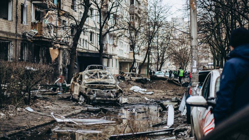 A wrecked, burned-out car lies in the yard of a high-rise residential building in Dniprovskyi district after a missile explosion on December 13, 2023 in Kyiv, Ukraine. For the second night in a row, Russia is attacking Kyiv with ballistic missiles. All ten missiles were intercepted by Ukrainian Air Defense Forces. However, fallen missiles' fragments resulted in destruction in Darnytskyi, Dniprovskyi and Desnyanskyi districts of Kyiv.
