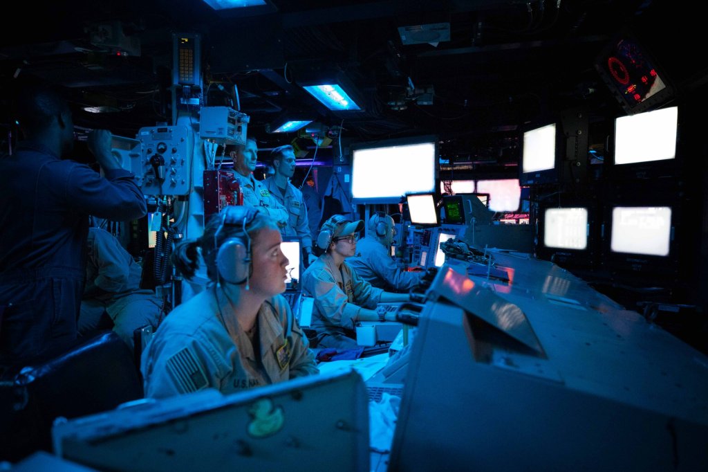 231019-N-GF955-1030 RED SEA (Oct. 19, 2023) Sailors assigned to the Arleigh Burke-class guided-missile destroyer USS Carney (DDG 64) stand watch in the ship’s Combat Information Center during an operation to defeat a combination of Houthi missiles and unmanned aerial vehicles, Oct. 19. Carney is deployed to the U.S. 5th Fleet area of operations to help ensure maritime security and stability in the Middle East region. (U.S. Navy photo by Mass Communication Specialist 2nd Class Aaron Lau)