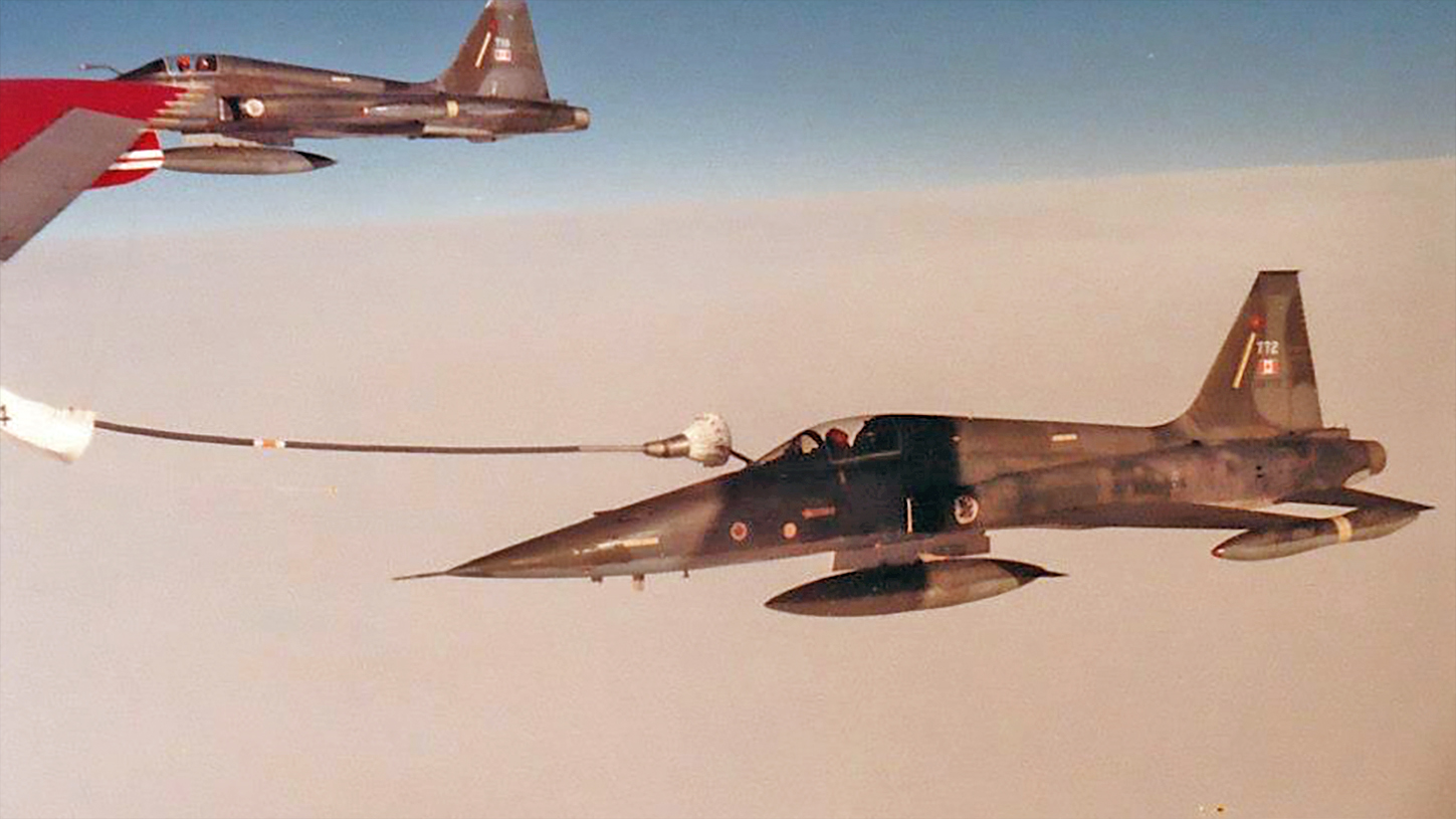 CF-5 refuels from a 707 tanker.