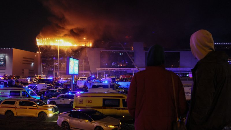 Emergency services vehicles are seen outside the burning Crocus City Hall concert hall following the shooting incident in Krasnogorsk, outside Moscow, on March 22, 2024. Gunmen opened fire at a concert hall in a Moscow suburb on March 22, 2024 leaving dead and wounded before a major fire spread through the building, Moscow's mayor and Russian news agencies reported.