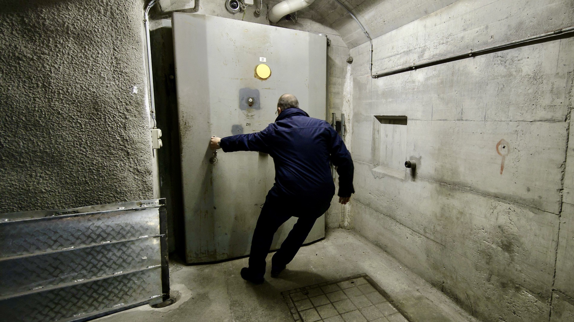 Patrick Mueller opens a bunker door of the Deltalis Swiss Mountain Data Center, a former Swiss Army bunker built in the Alps during the Cold War, on November 18, 2013, near Attinghausen, Central Switzerland.