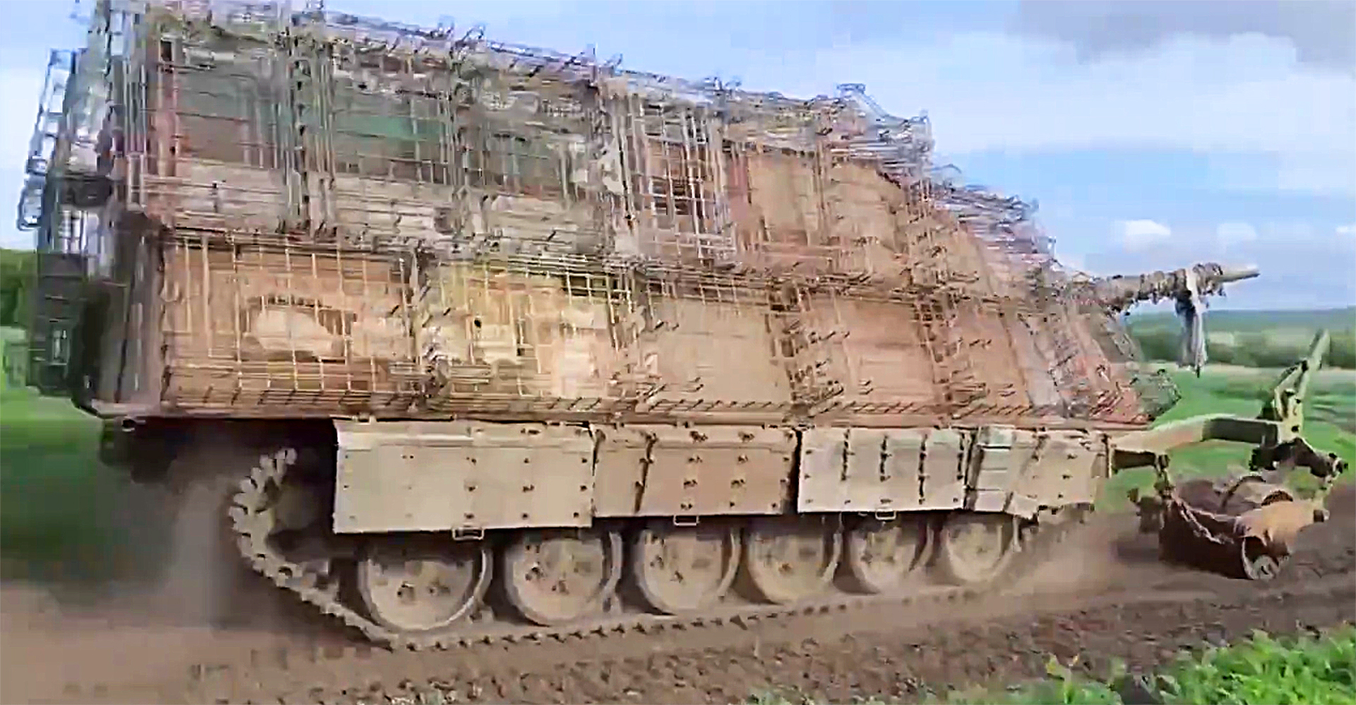 Russian 'turtle tank' seen operating with additional cage armor and an attached mine roller
