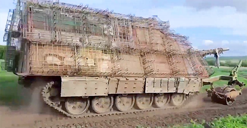 Russian 'turtle tank' seen operating with additional cage armor and an attached mine roller