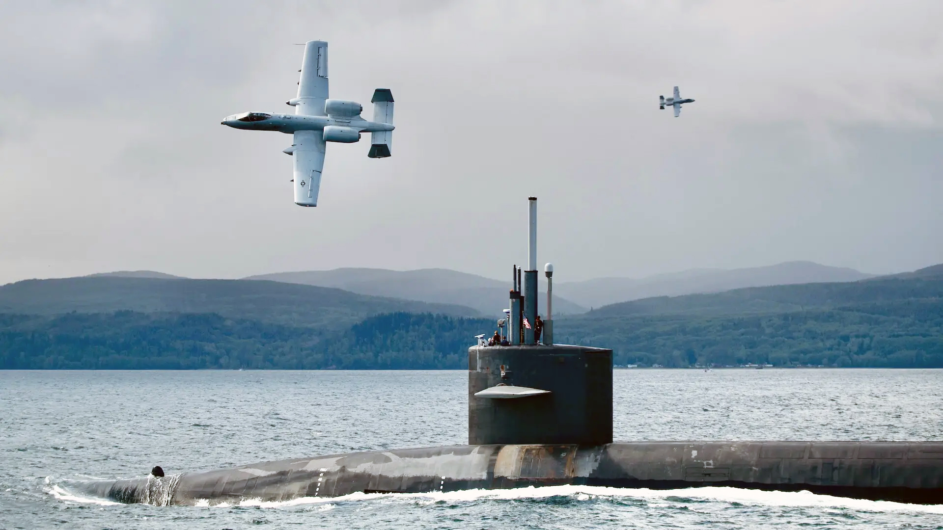 STRAIT OF SAN JUAN DE FUCA, Wash. (May 6, 2024) The Ohio-class ballistic missile submarine USS Nebraska (SSBN 739) transits the Strait of San Juan de Fuca escorted by U.S. Air Force A-10 Thunderbolt II aircraft and U.S. Coast Guard screening escort vessels. Joint operations, such as this one which involved the Air Force, Coast Guard, and Navy, ensure the U.S. military is ready to meet its security commitments at home and abroad including commitments to our allies and partners. (U.S. Navy photo by Mass Communication Specialist 2nd Class Gwendelyn Ohrazda/Released)