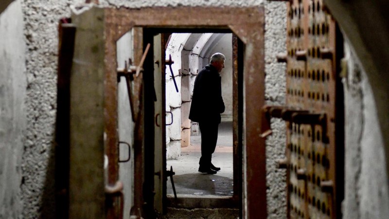 In this photograph taken on February 2, 2020, Astrit Imeri, a former soldier, walks inside The Cold War Tunnel Museum at Gjirokastra, Albania. - Snaking beneath a fortress in southern Albania, a covert tunnel network built during the country's communist era captures the secrecy and paranoia that defined the long rule of former tyrant Enver Hoxha.Today communism is gone and the military bunker is a tourist attraction, still drawing rare visitors during the pandemic, when themes of fear, isolation and confinement are particularly resonant. The sprawling underground complex, now dubbed the Cold War tunnel, is part of a vast and costly "bunkerisation" project spearheaded by Hoxha, who was gripped by anxiety of a possible foreign invasion during his 40-year isolationist rule. (Photo by Gent SHKULLAKU / AFP) (Photo by GENT SHKULLAKU/AFP via Getty Images)