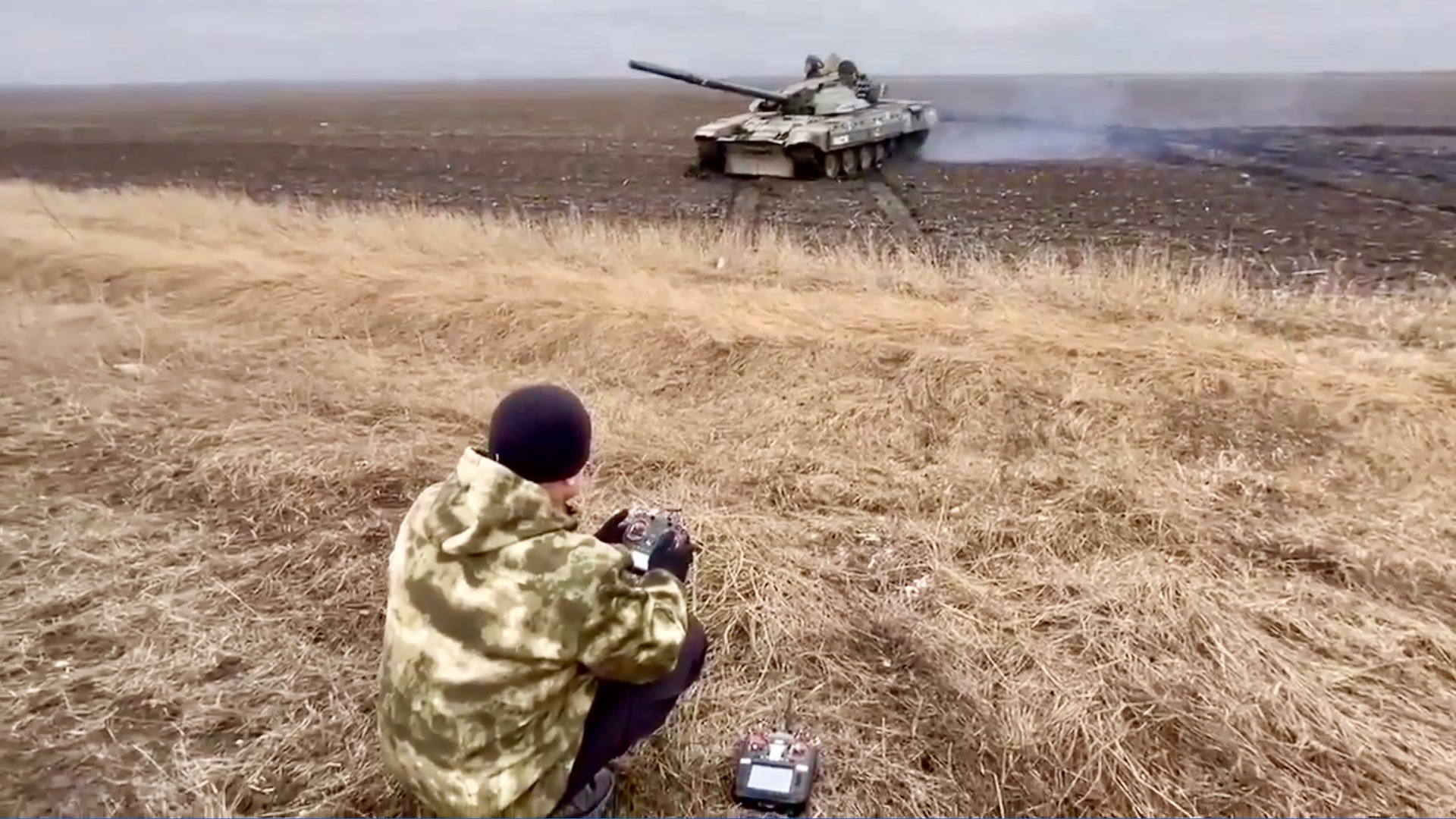 A Russian operative controls a captured Ukrainian tank via remote controls.