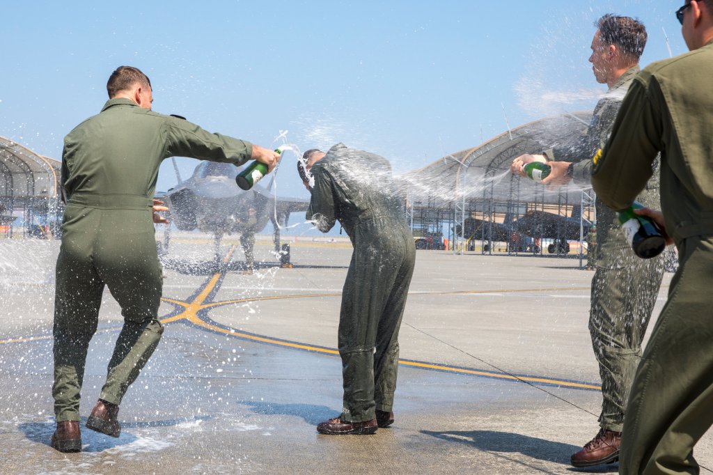 U.S. Marine Corps Lt. Col. Alexander Mellman, the commanding officer of Marine Fighter Attack Squadron (VMFA) 242, Marine Aircraft Group 12, 1st Marine Aircraft Wing, is greeted by U.S. Marines after his final flight at Marine Corps Air Station Iwakuni, Japan, June 11, 2024. Mellman conducted his final flight in honor of his 20 years of service in the U.S. Marine Corps. Mellman is a native of Connecticut. (U.S. Marine Corps photo by Cpl. Chloe Johnson)