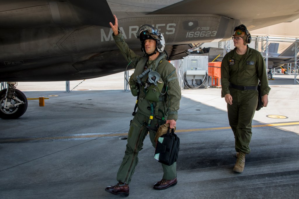 U.S. Marine Corps Lt. Col. Alexander Mellman, the commanding officer of Marine Fighter Attack Squadron (VMFA) 242, Marine Aircraft Group 12, 1st Marine Aircraft Wing, conducts preflight checks before his final flight at Marine Corps Air Station Iwakuni, Japan, June 11, 2024. Mellman conducted his final flight in honor of his 20 years of service in the U.S. Marine Corps. Mellman is a native of Connecticut. (U.S. Marine Corps photo by Cpl. Chloe Johnson)