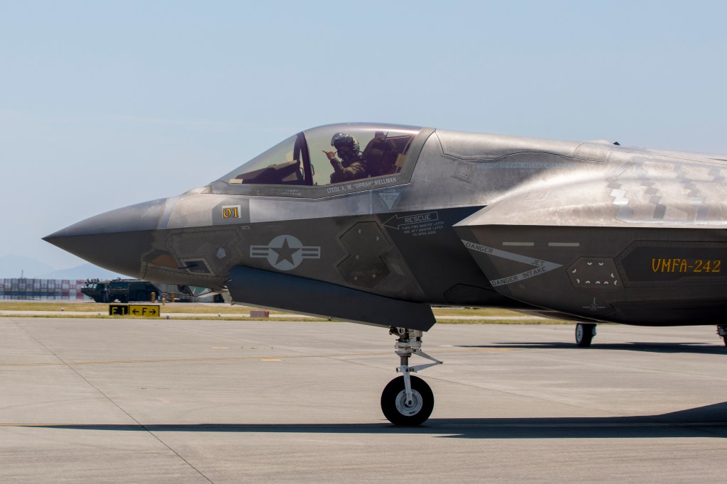 U.S. Marine Corps Lt. Col. Alexander Mellman, the commanding officer of Marine Fighter Attack Squadron (VMFA) 242, Marine Aircraft Group 12, 1st Marine Aircraft Wing, poses for the camera while taxiing to the runway in an F-35B Lightning II aircraft during his final flight at Marine Corps Air Station Iwakuni, Japan, June 13, 2024. This flight was conducted to honor Mellman’s 20 years of service in the U.S. Marine Corps. Mellman is a native of Connecticut. (U.S. Marine Corps photo by Cpl. Chloe Johnson)