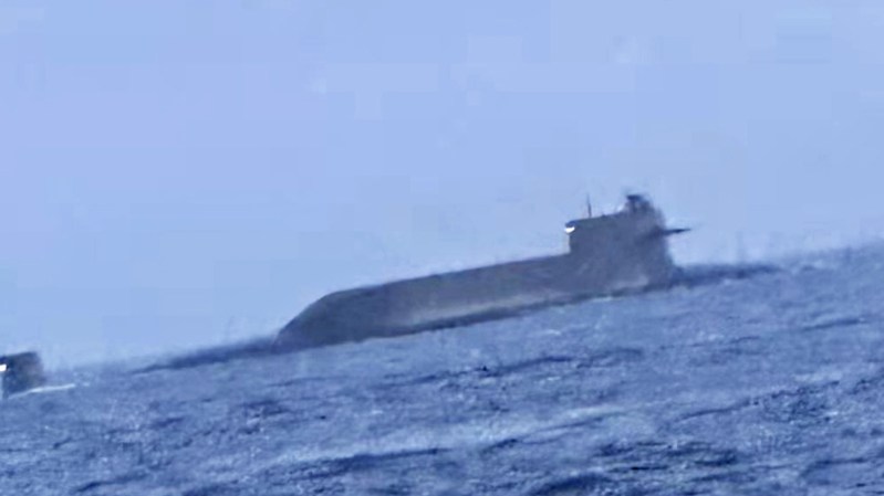 A Chinese nuclear-powered ballistic missile submarine (SSBN) has surfaced in the Taiwan Strait, prompting the Taiwanese defense ministry to issue a reassurance that it has a “grasp” of the situation. The appearance of the submarine follows recent activity by People’s Liberation Army aircraft and vessels around Taiwan, which Beijing views as a breakaway province that must eventually be reunited with the mainland. However, while uncommon, all signs point to the submarine’s presence in the strait as being part of a transit back to port.