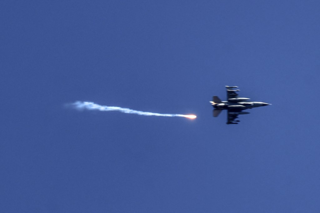 A picture taken from Kiryat Shmona in northern Israel shows an Israeli fighter jet firing a flare over southern Lebanon on May 16, 2024, amid ongoing cross-border clashes between Israeli troops and Hezbollah fighters. (Photo by Menahem KAHANA / AFP) (Photo by MENAHEM KAHANA/AFP via Getty Images)