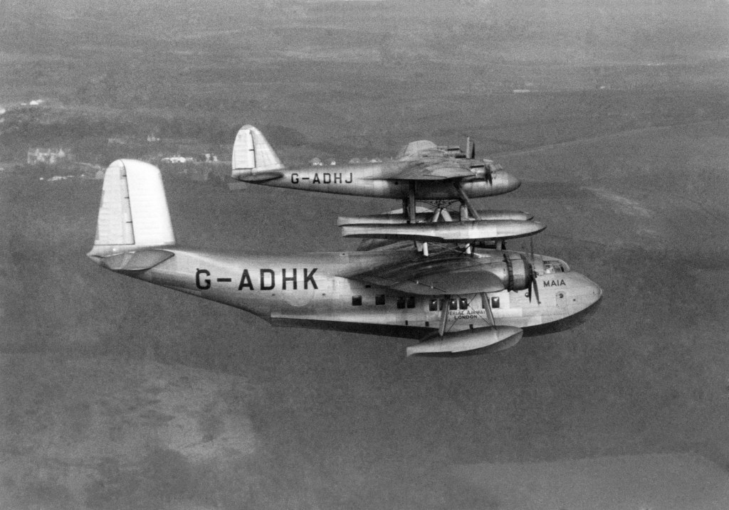 The idea was to launch the heavily loaded mail plane Mercury from the back of the lightly loaded Maia after the combination had climb to cruising level. The Maia was an adapted Short S.30 Empire flying boat. Flying trials began in early 1938 with the first separation on 6 February and the first long-distance flight was made from Foynes in Ireland on 20 July. Captain Don Bennett (who became a famous W.W.2 Pathfinder pilot) then flew Mercury on to Montreal, a distance of 2930 miles in 20 hours 20 minutes. He later flew south to New York where Mercury was reunited with Maia. WW2 put paid to any further development of this interesting conception. February 1938 P004825 (Photo by WATFORD/Mirrorpix/Mirrorpix via Getty Images)