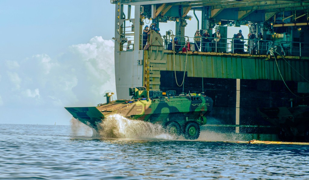 A U.S. Marine Corps amphibious combat vehicle attached to Alpha Company, Battalion Landing Team 1/5, 15th Marine Expeditionary Unit, splashes off the amphibious dock landing ship USS Harpers Ferry (LSD 49) during Exercise Balikatan 24 in Naval Detachment Oyster Bay, Palawan, Philippines, May 4, 2024. BK 24 is an annual exercise between the Armed Forces of the Philippines and the U.S. military designed to strengthen bilateral interoperability, capabilities, trust, and cooperation built over decades of shared experiences. (U.S. Marine Corps photo by Lance Cpl. Peyton Kahle)