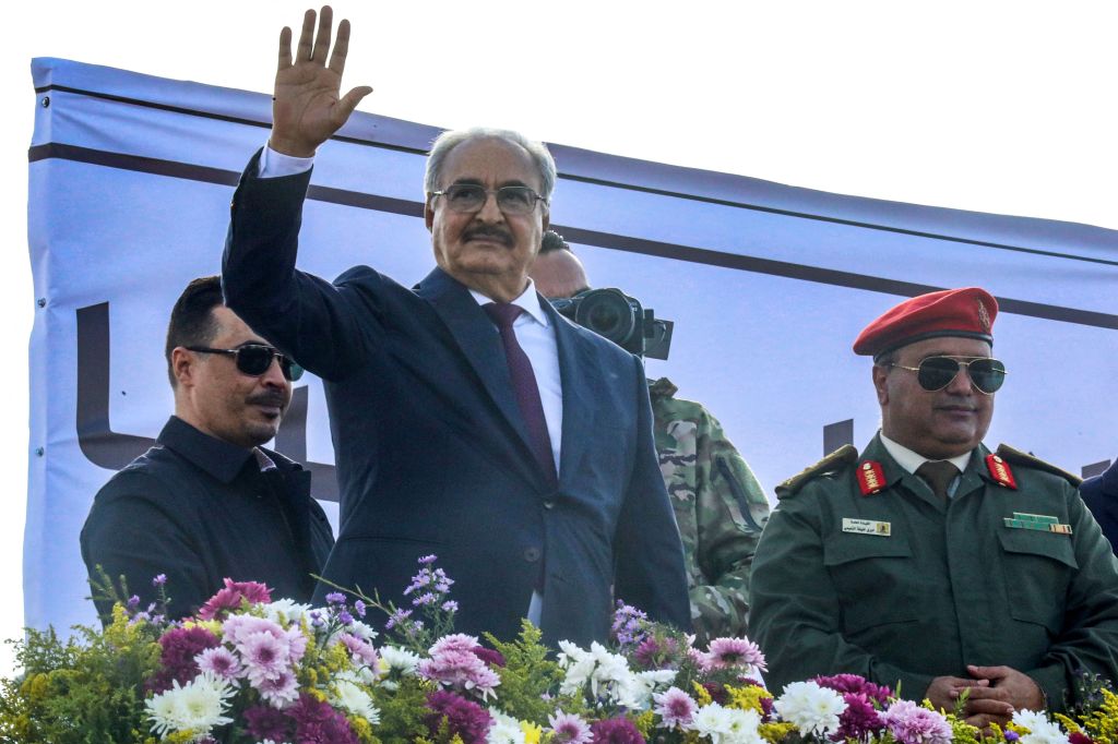 Libya's eastern military chief Khalifa Haftar (2nd-L) waves after a speech at a rally marking the 71st anniversary of the country's independence from Italy in the eastern city of Benghazi on December 24, 2022. (Photo by Abdullah DOMA / AFP) (Photo by ABDULLAH DOMA/AFP via Getty Images)