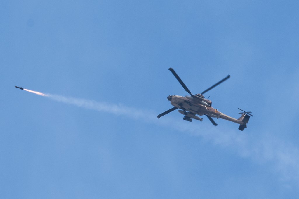 A picture taken from southern Israel near the border with the Gaza Strip on December 8, 2023, shows an Israeli army helicopter firing on a target in northern Gaza, amid continuing battles between Israel and the militant group Hamas. (Photo by JACK GUEZ / AFP) (Photo by JACK GUEZ/AFP via Getty Images)