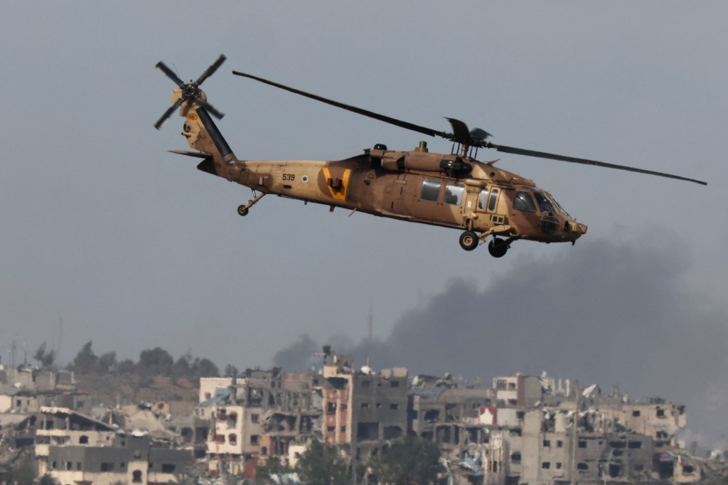 A picture taken from southern Israel near the border with the Gaza Strip on December 9, 2023, shows an Israeli military rescue helicopter arriving to rescue soldiers, amid continuing battles with the militant group Hamas in the Palestinian territory. (Photo by JACK GUEZ / AFP) (Photo by JACK GUEZ/AFP via Getty Images)