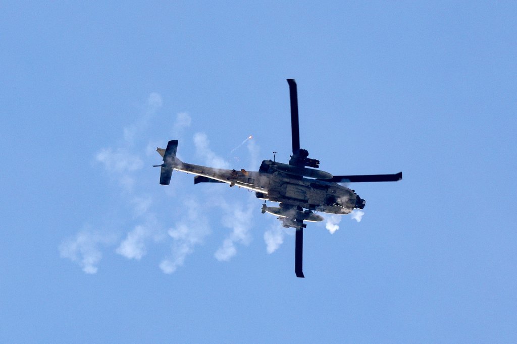 A picture taken from southern Israel shows an Israeli army helicopter firing at targets in the Gaza Strip on January 18, 2024, amid ongoing battles between Israel and the Palestinian militant group Hamas. (Photo by JACK GUEZ / AFP) (Photo by JACK GUEZ/AFP via Getty Images)