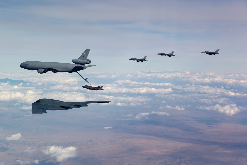 A United States Air Force KC-10 refuels an F-35, while a B-2 and three F-16 aircraft await on the wing after conducting flight test operations in the R2508 airspace near Edwards AFB, CA. (U.S. Air Force Photo by Christian Turner)