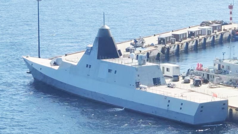 A new photo has emerged of China’s mysterious stealthy Chinese corvette or light frigate, an intriguing design, with apparent low-observable features, which you can read more about here. In fact, the latest photo raises more questions than it answers, in particular the presumed HQ-10 surface-to-air missile launcher at the rear of the vessel apparently being something else entirely.