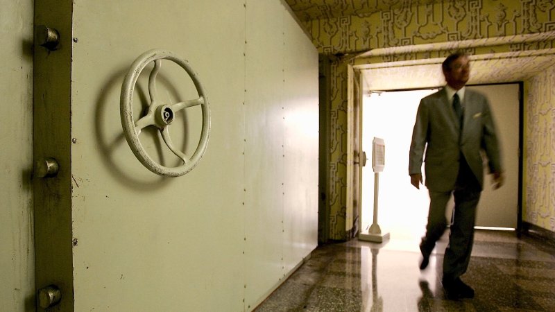 WHITE SULPHUR SPRINGS, WV - JULY 14: A resort employee passes by the Hotel Blast Door, which weighs 18 tons and serves as an entrance to a former government relocation facility, also know as "the bunker," at Greenbrier Resort July 14, 2006 in White Sulphur Springs, West Virginia. The bunker, codenamed "Project Greek Island" and planned by the Eisenhower Administration, was a 112,000 square-foot shelter constructed beneath the Greenbrier Resort's West Virginia Wing, to serve as a relocation site for members of the U.S. Congress and associated staff in the event of a nuclear attack on the U.S. soil. The facility was built between 1958 and 1961 and was maintained in a state of operational readiness until the government terminated the lease with the resort in 1995. The bunker will be reopened for public tours on August 20 after a two-year-long renovation. (Photo by Alex Wong/Getty Images)