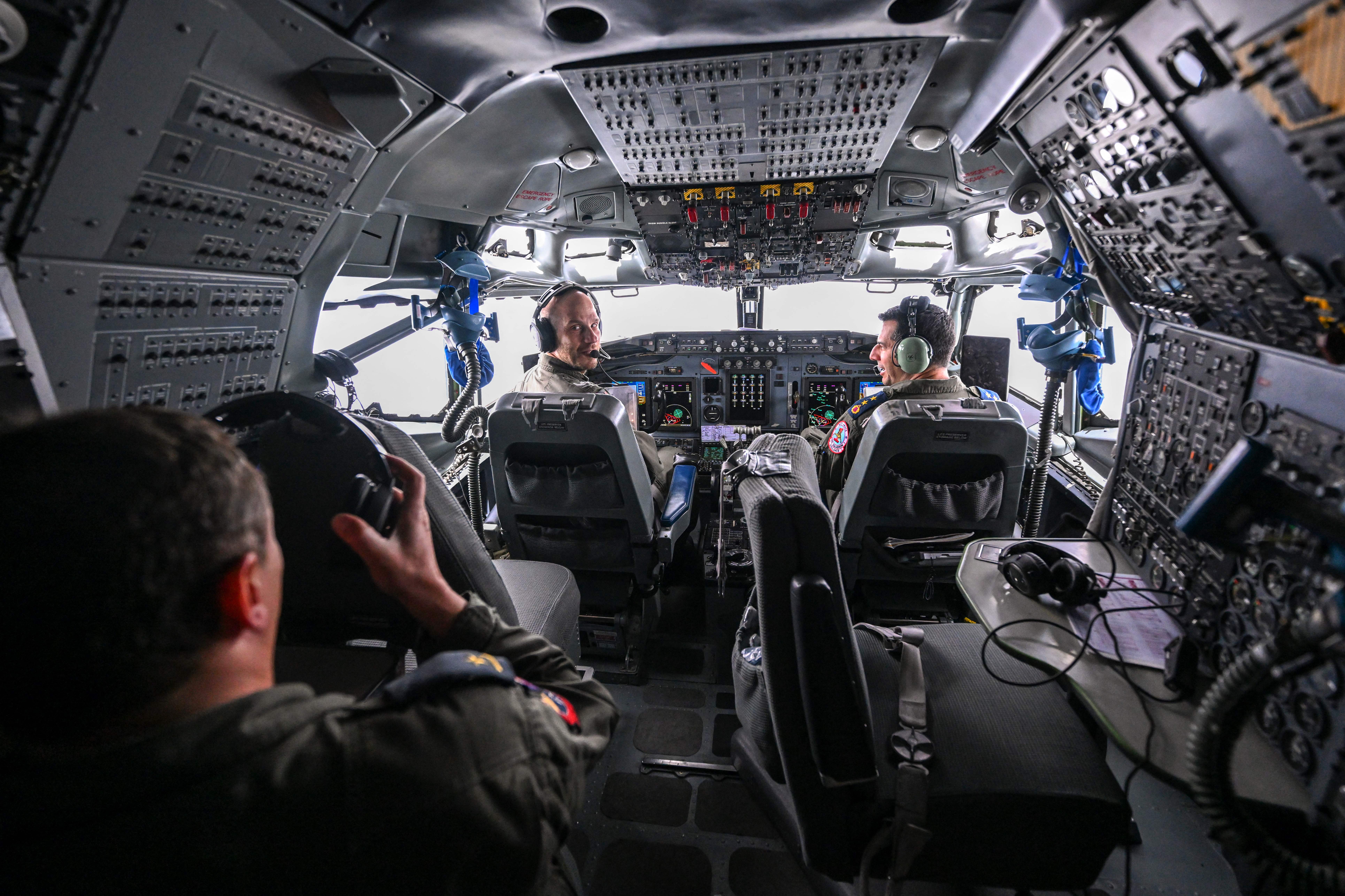 Pilots sit in the cockpit of a NATO Airborne Warning and Control System (AWACS) aircraft, which participates in the German-led multinational exercise Air Defender 23, during a flight over northern Germany from the military base of Geilenkirchen, western Germany, on June 20, 2023. NATO AWACS enables the exercise by providing airborne command and control with its long-range radar and passive sensors for the participating fighter aircraft. Air Defender 23 is the largest air force deployment exercise in NATO's history. Under the lead of the German air force, about 10,000 troops from Allied and Partner nations practice a fictitious collective defence scenario, in which Allies and Partners deploy their forces to Germany to defend NATO territory with swift and decisive action. (Photo by Ina FASSBENDER / AFP) (Photo by INA FASSBENDER/AFP via Getty Images)