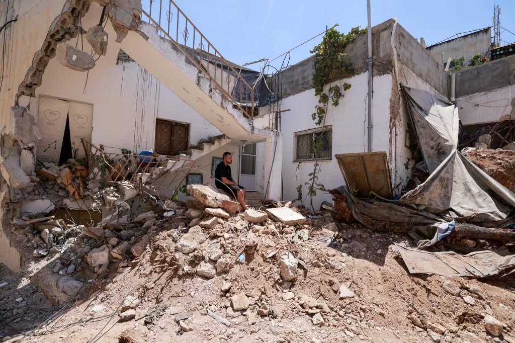 Palestinians inspect the destruction following an Israeli raid in Jenin city in the occupied West Bank on August 6, 2024. (Photo by Jaafar ASHTIYEH / AFP) (Photo by JAAFAR ASHTIYEH/AFP via Getty Images)