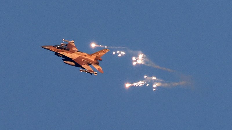 This photo taken from a position in northern Israel shows an Israeli Air Force fighter jet firing flares as it flies to intercept a hostile aircraft that launched from Lebanon over the border area with south Lebanon on August 25, 2024. The Israeli military announced early August 25, 2024 that it was conducting pre-emptive strikes in Lebanon after detecting preparations for "large-scale" attacks by the Iran-backed militant group Hezbollah. Hezbollah said August 25, 2024 it had launched more than 320 rockets at Israel overnight, targeting a string of military positions, even as Israel's military said it was carrying out pre-emptive strikes against the group. (Photo by Jalaa MAREY / AFP) (Photo by JALAA MAREY/AFP via Getty Images)