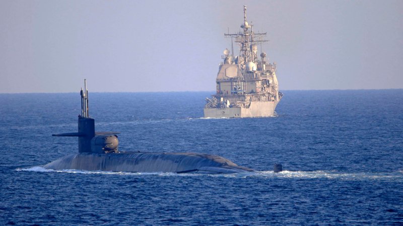 The Ohio-class, guided-missile submarine USS Georgia (SSGN 729) transits with the Ticonderoga-class guided-missile cruiser USS Port Royal (CG 73) and the Ticonderoga-class guided-missile cruiser USS Philippine Sea (CG 58), not shown, on the Strait of Hormuz, Dec. 21. Philippine Sea is deployed to the U.S. 5th Fleet area of operations in support of naval operations to ensure maritime stability and security in the Central Region, connecting the Mediterranean and Pacific through the Western Indian Ocean and three critical chokepoints to the free flow of global commerce.