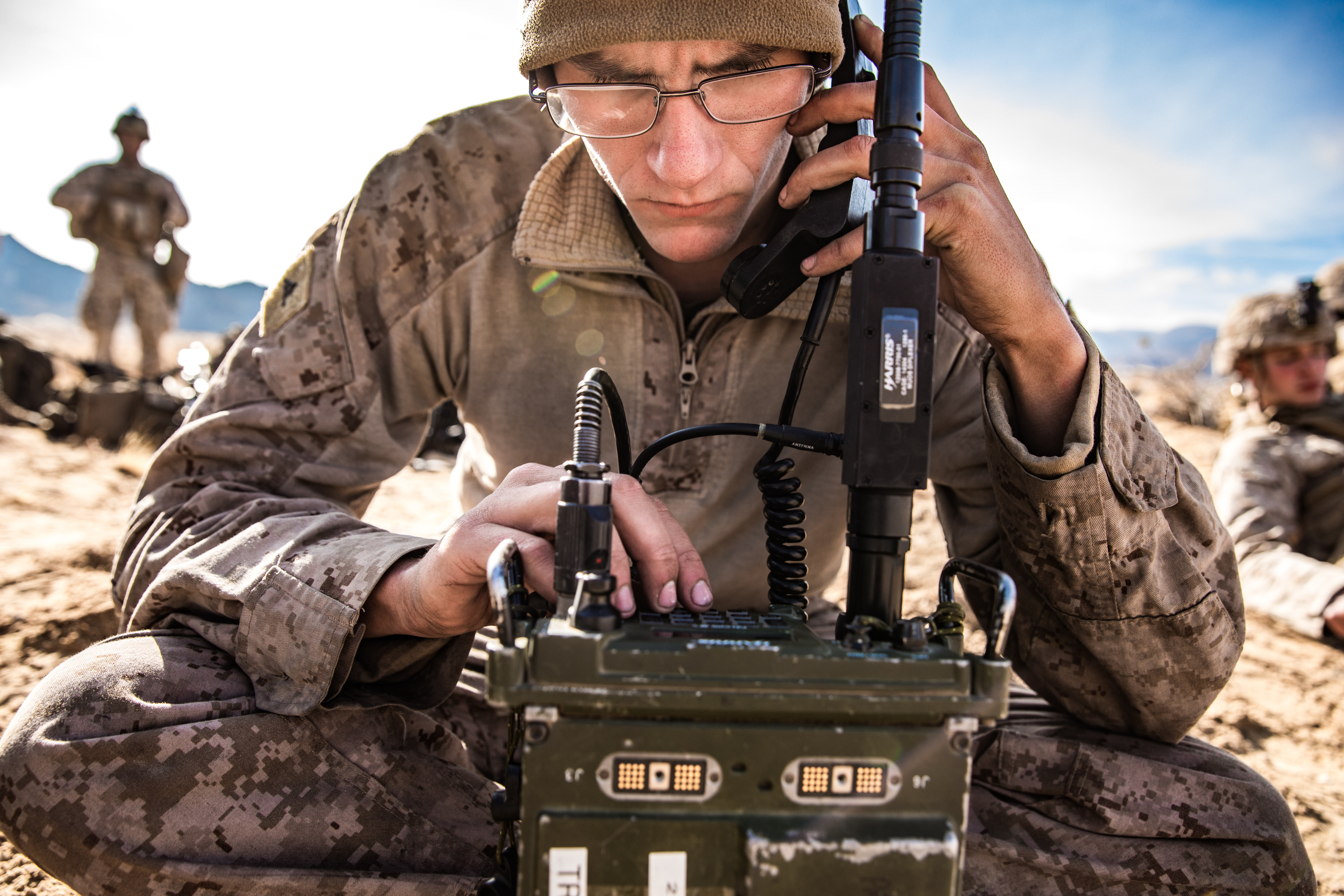 U.S. Marine Corps Lance Cpl. Zachary Cooper, a radio operator with 3rd Amphibian Assault Battalion, 1st Marine Division, uses the AN/PRC-117 Multiband Manpack Radio to set up communication during exercise Steel Knight (SK20) at Marine Corps Air Ground Combat Center Twentynine Palms, California, Dec. 5, 2019. SK20 is an annual training exercise executed by approximately 13,000 Marines and Sailors designed to improve and assess the 1st Marine Division's ability to fight and win against a peer or near-peer threat. (U.S. Marine Corps photo by Cpl. Alexa M. Hernandez)