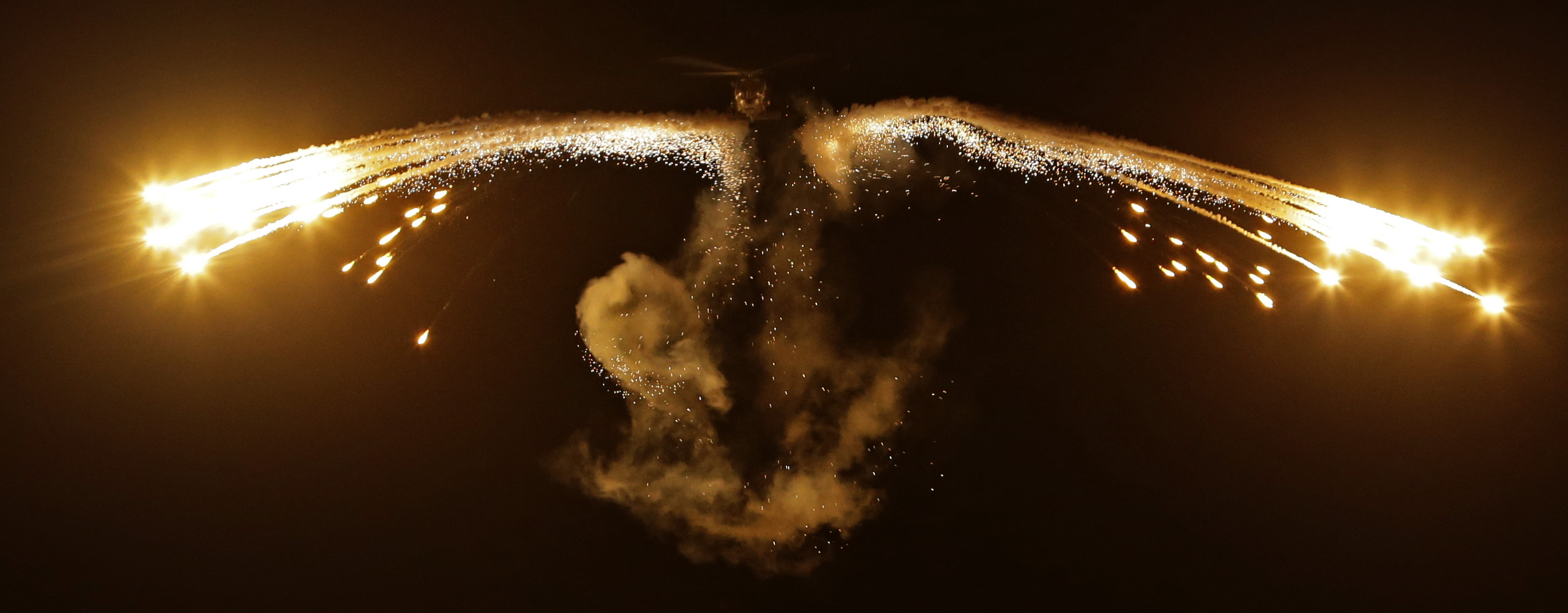 HMAS Melbourne's embarked S-70B-2 Seahawk aircraft, Dominator, deploys decoy flares off the stern in celebration of its 5000 flying hours that it attained today on patrol in the Middle East Area of Operations. *** Local Caption *** HMAS Melbourne's embarked S-70B-2 Seahawk Dominator (073) has attained 5000 hours flying time. This milestone was achieved during a routine patrol off the coast of Somalia. The aircraft is conducting patrols in support of counter piracy tasking under the direction of Combined Task Force 150.