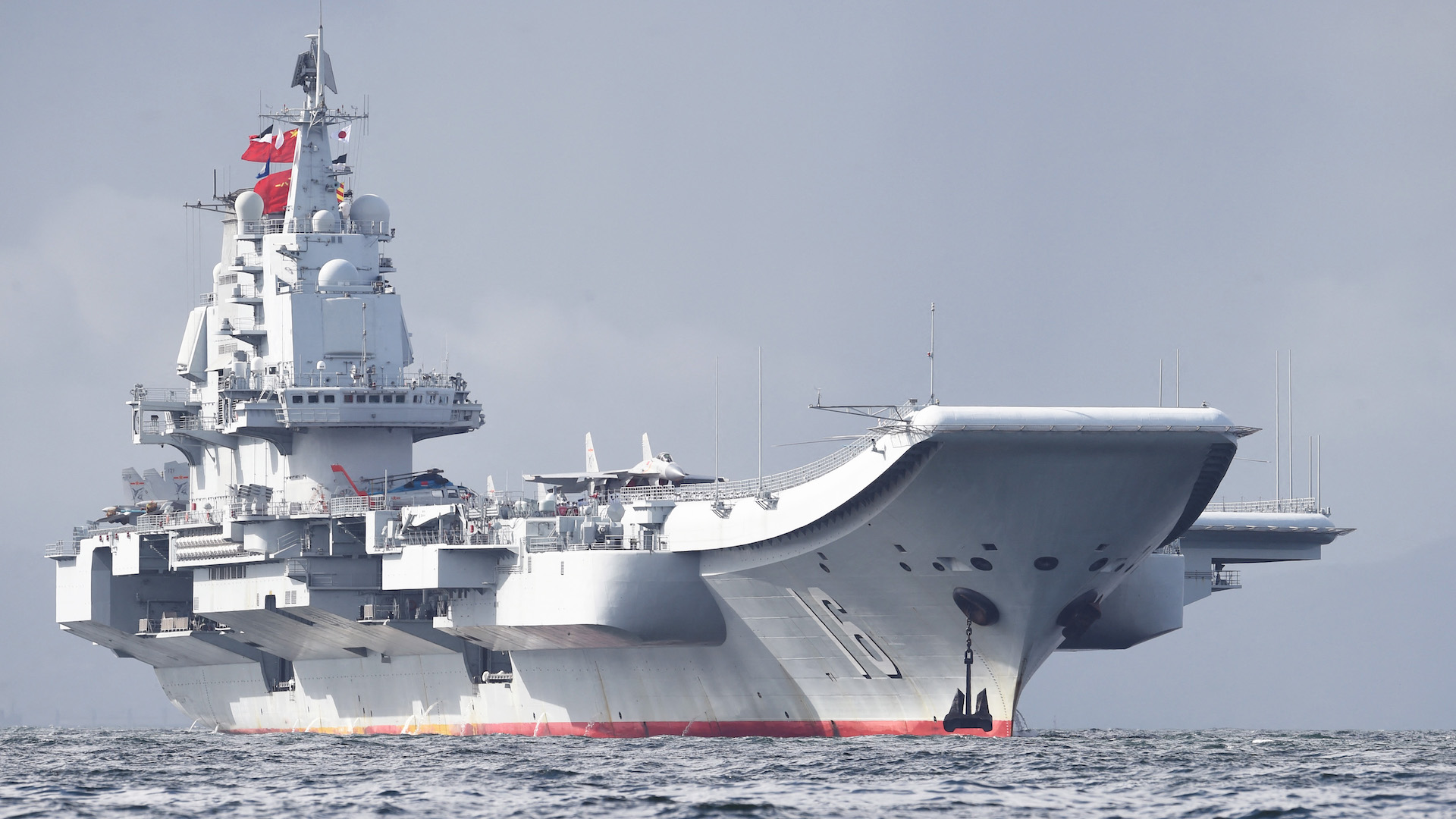 China's sole aircraft carrier, the Liaoning, arrives in Hong Kong waters on July 7, 2017, less than a week after a high-profile visit by president Xi Jinping. - China's national defence ministry had said the Liaoning, named after a northeastern Chinese province, was part of a flotilla on a "routine training mission" and would make a port of call in the former British colony.