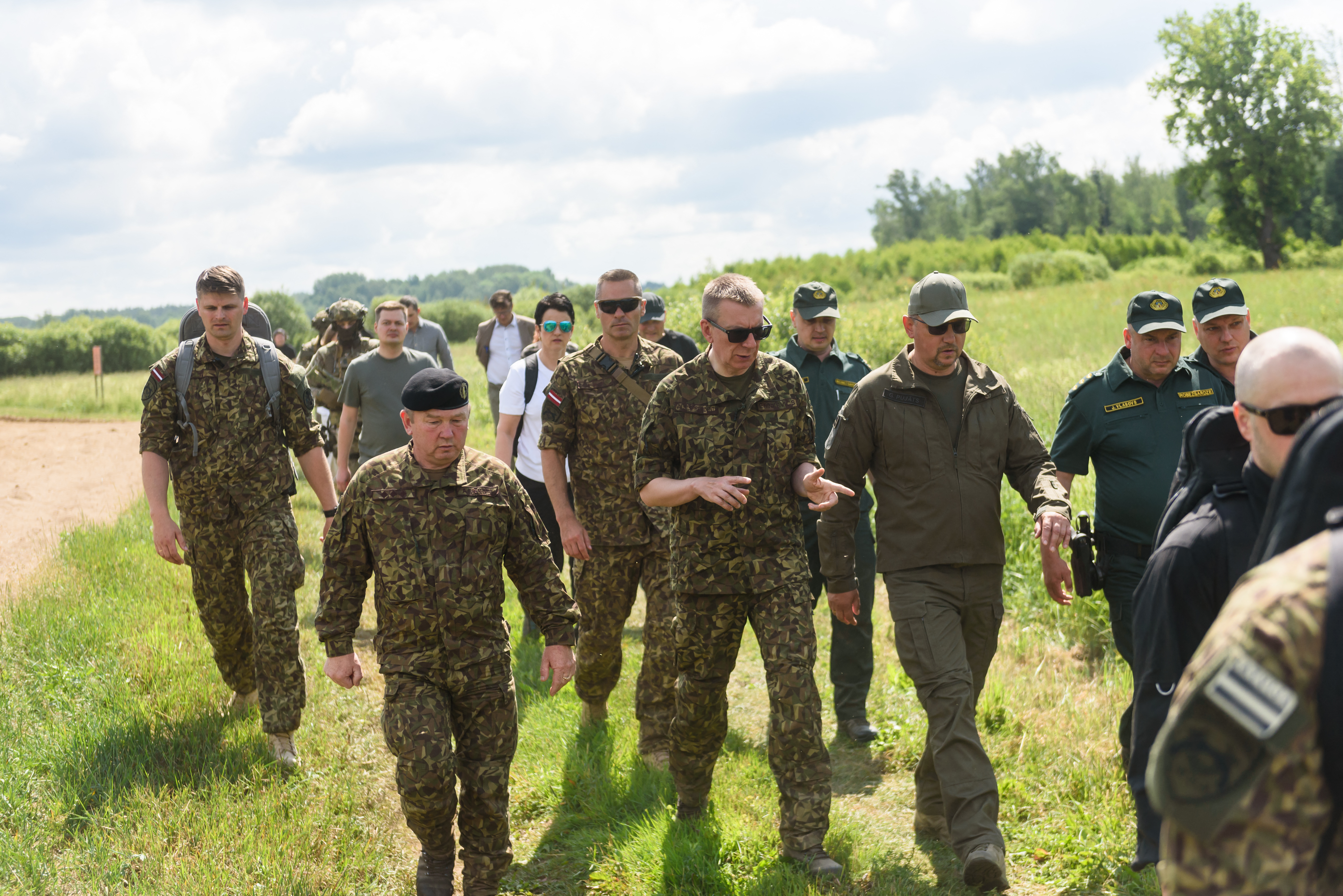 Latvia's President Edgars Rinkevics (C) inspects the construction of a border wall in Karsava, Latvia, close to the Baltic country's border with Russia, on June 18, 2024. (Photo by Gints Ivuskans / AFP) (Photo by GINTS IVUSKANS/AFP via Getty Images)