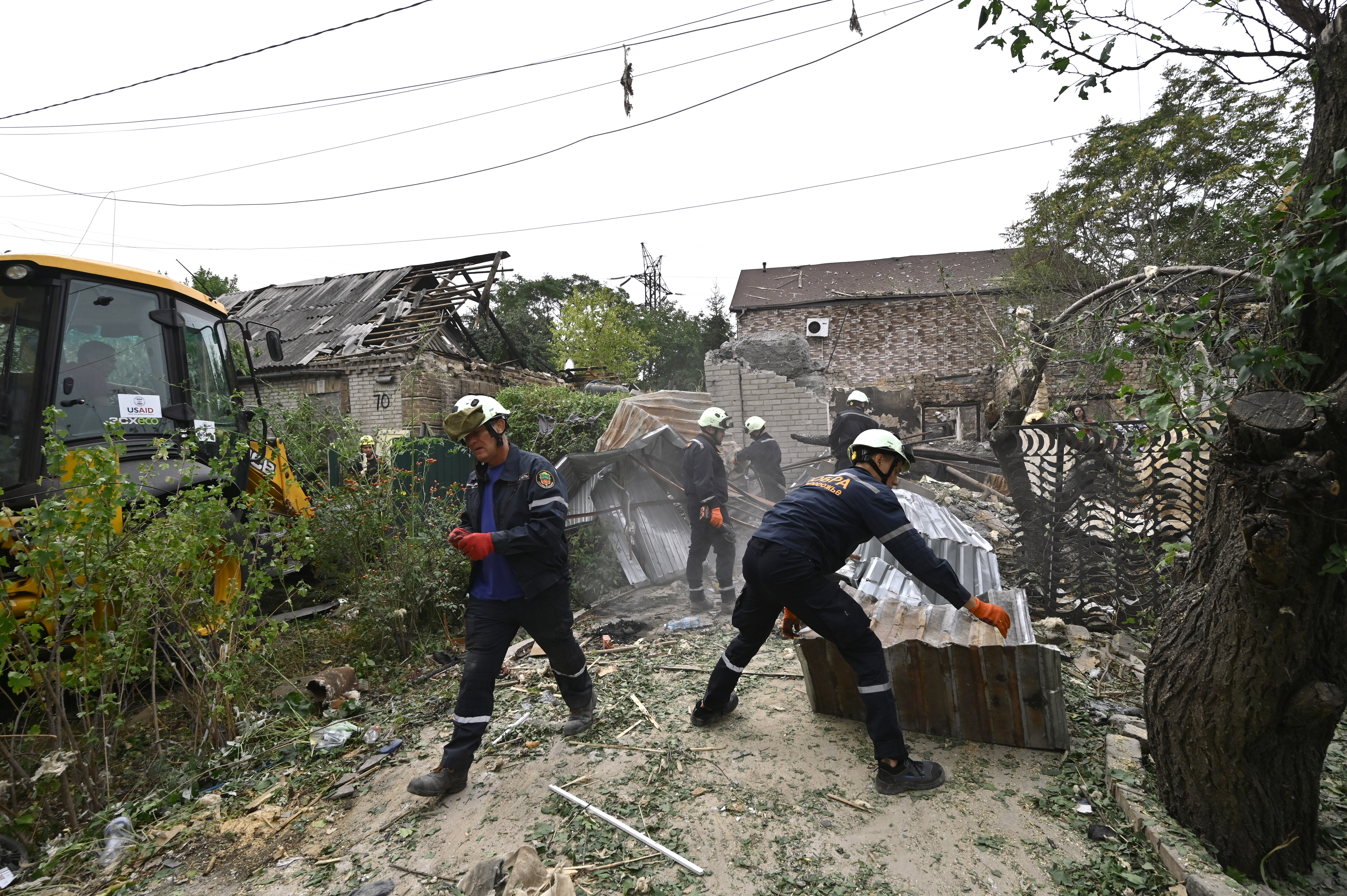 ZAPORIZHZHIA, UKRAINE - AUGUST 27, 2024 - Workers of the Kobra emergency and rescue service remove rubble at a house destroyed after a Russian Shahed drone fell onto a residential area in Zaporizhzhia, southeastern Ukraine. (Photo credit should read Dmytro Smolienko / Ukrinform/Future Publishing via Getty Images)