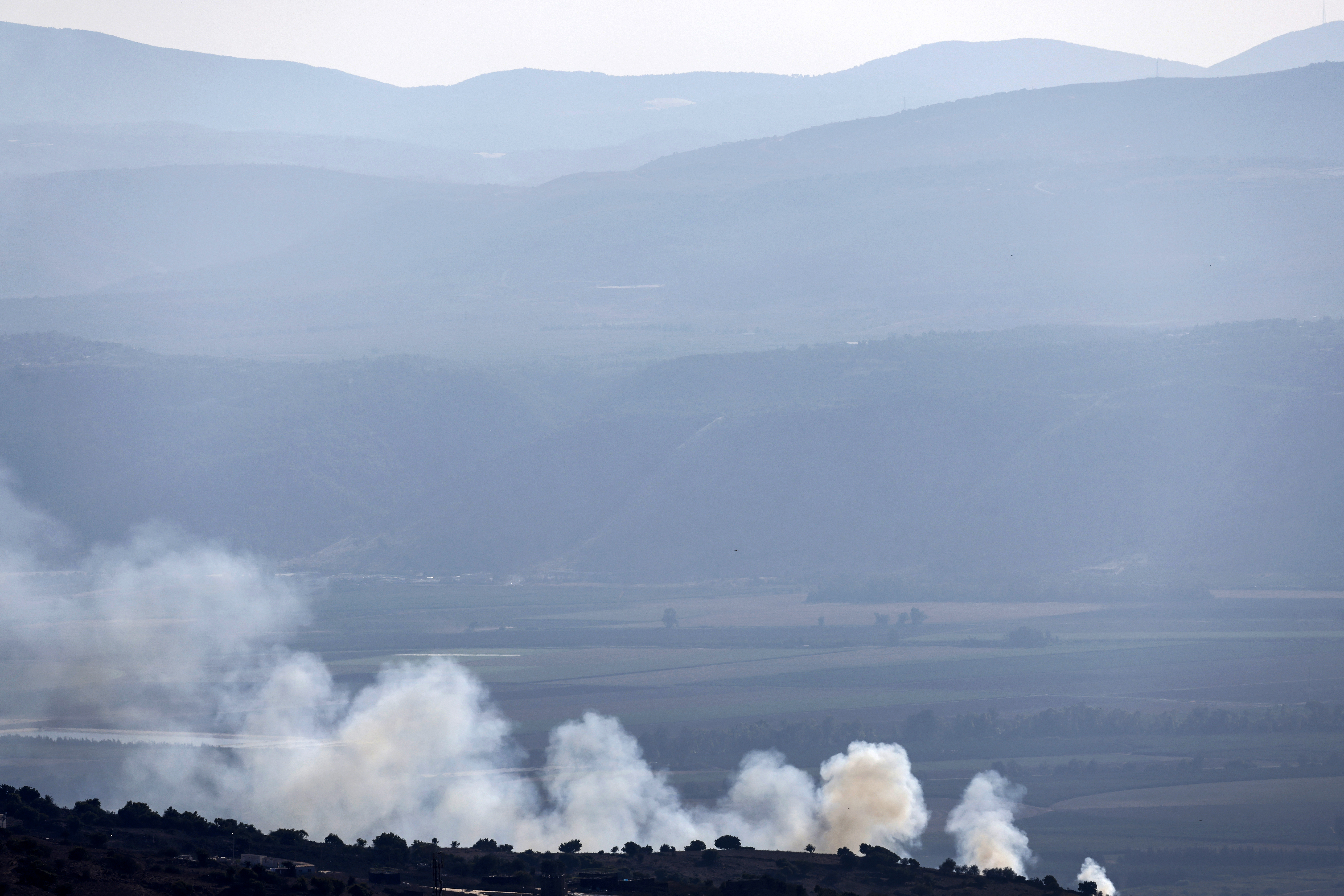 Smoke billows after rockets were fired from southern Lebanon over the Upper Galilee region in northern Israel on September 11, 2024. Lebanon's Hezbollah has traded near-daily fire with Israeli forces in support of ally Hamas since the Palestinian militant group's October 7 attack triggered war in the Gaza Strip, with repeated escalations during more than 11 months of the cross-border violence. (Photo by Jalaa MAREY / AFP) (Photo by JALAA MAREY/AFP via Getty Images)