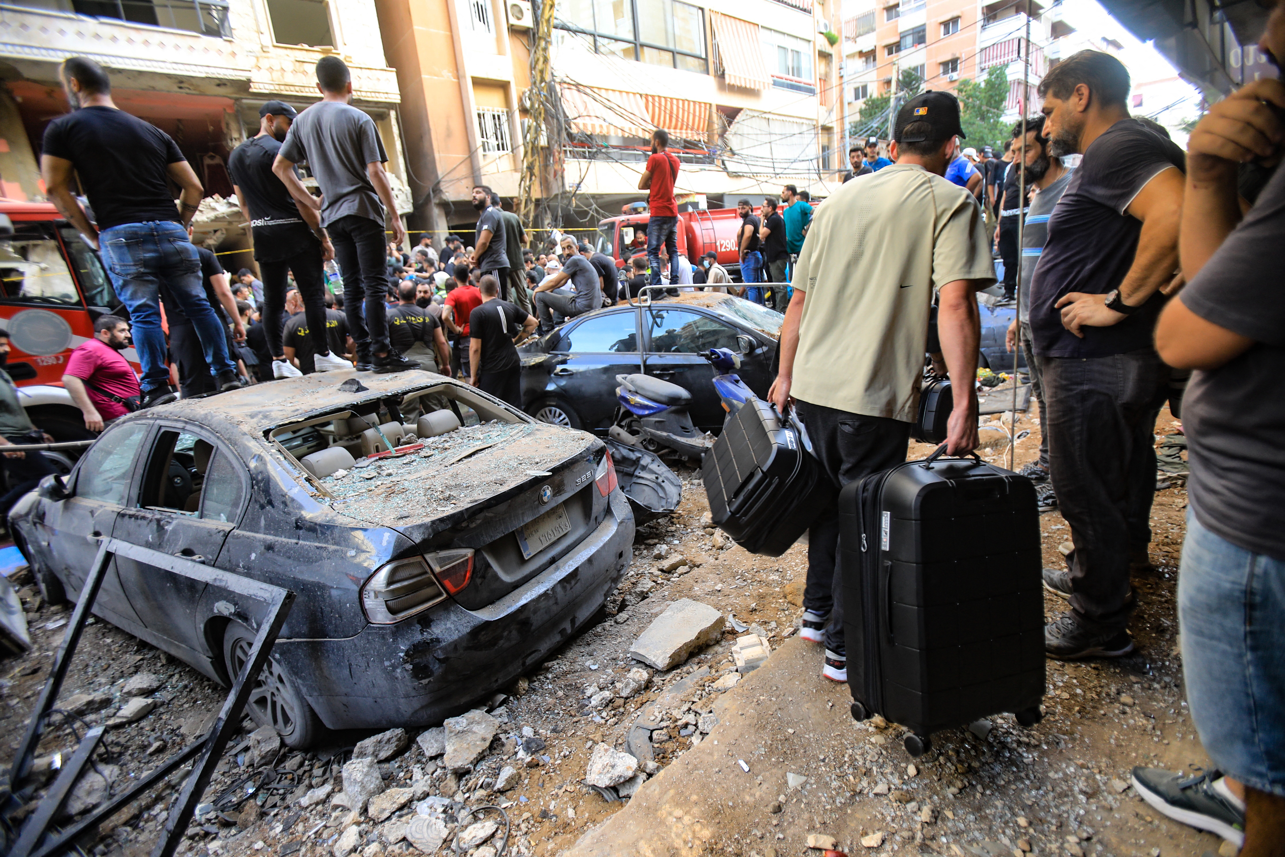 People gather in front of a building targeted by an Israeli strike in Beirut's southern suburbs on September 20, 2024. The strike on Hezbollah's stronghold in Lebanon's capital Beirut reportedly killed at least eight people and wounded dozens of others, with a source close to the movement saying a top military leader was dead. (Photo by AFP) (Photo by -/AFP via Getty Images)