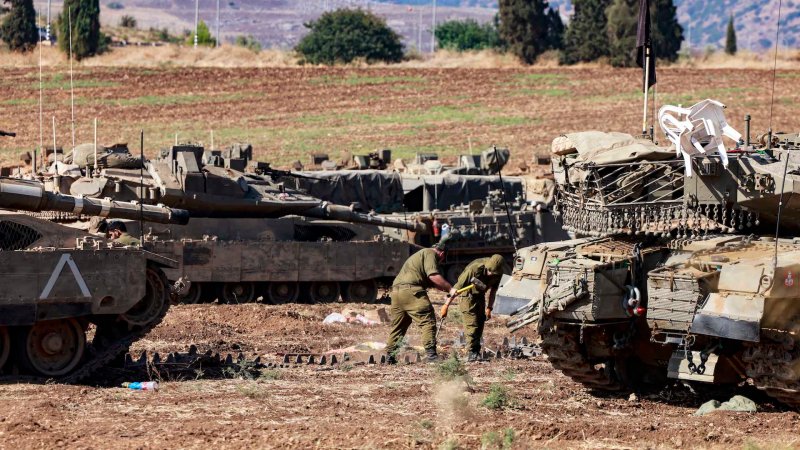 Israeli soldiers work on the maintenance of tanks deployed in the Upper Galilee region of northern Israel near the border with Lebanon on September 29, 2024. Israel said on September 29 that it was carrying out new air raids against "dozens" of Hezbollah targets in Lebanon, after killing the Iran-backed group's leader, Hassan Nasrallah. Israel has also raised the prospect of a ground operation against Hezbollah, prompting widespread international concern.