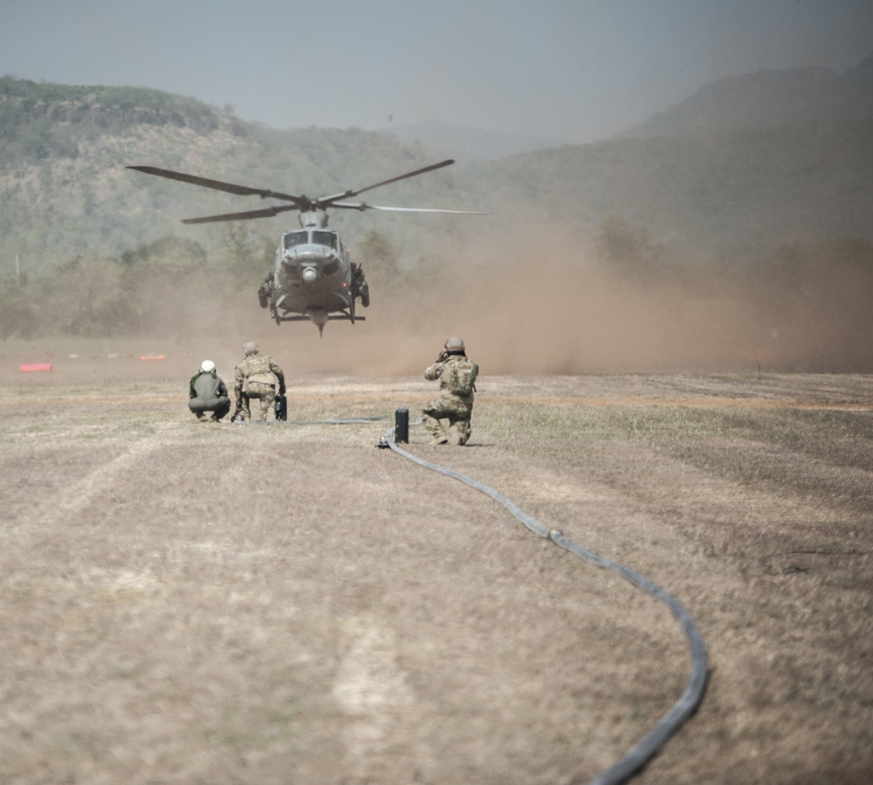 U.S. Air Force 18th Logistics Readiness Squadron forward area refueling point (FARP) technicians and 1st Special Operations Squadron loadmasters prepare to perform FARP operations with a U.S. Marine Corps 1st Marine Aviation Wing UH-1 Huey Feb. 14, 2018, at Chandy Range, Thailand. The 353rd Special Operations Group’s FARP capability provides a covert refueling option in situations where traditional refueling capabilities are not feasible. (U.S. Air Force photo by Capt. Jessica Tait)