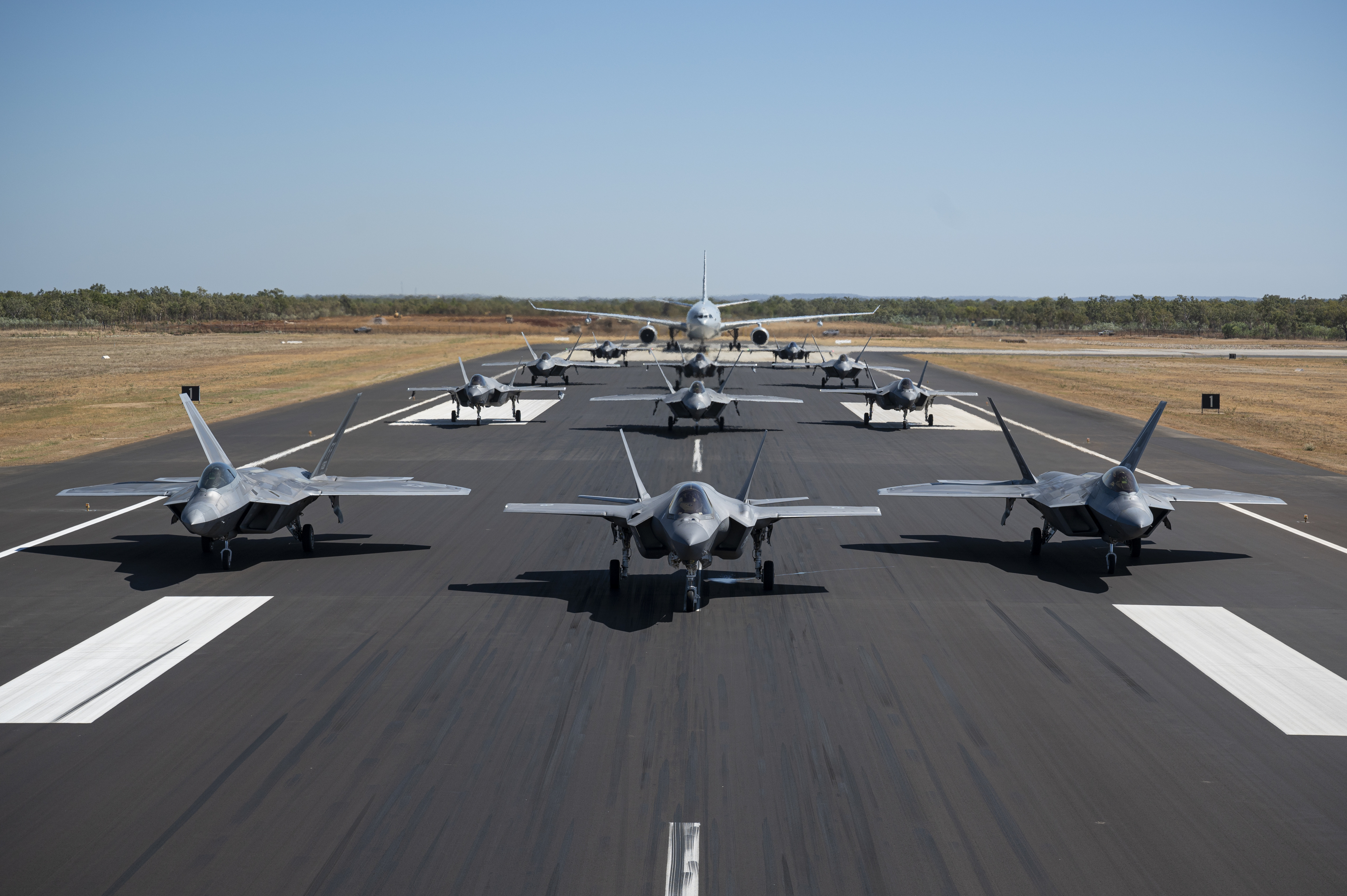 U.S. Air Force F-22A Raptors assigned to the 27th Expeditionary Fighter Squadron along with Royal Australian Air Force F-35A Lightning IIs from No 75 Squadron and a KC-30A Multi Role Tanker Transport aircraft from No 33 Squadron, demonstrate a show of force by conducting an elephant walk at RAAF Base Tindal, Australia, July 31, 2024. Exercise Pitch Black showcases our capability to come together with our Allies and partners to synchronize efforts across a Joint, Combined Force. To deter aggression within the Indo-Pacific, our Air Forces must be ready and resilient in the face of future challenges and prepared to integrate with regional and global counterparts. (U.S. Air Force photo by Staff Sgt. Spencer Tobler)