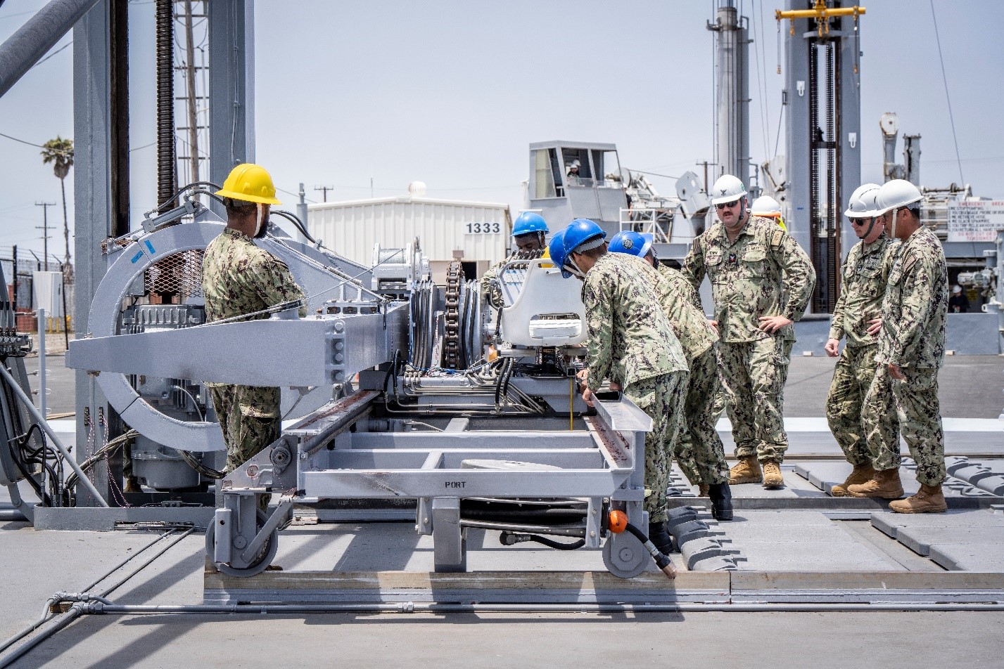 Sailors from the Navy Expeditionary Logistics Support Group and USS Chosin (CG 65) prepare to operate the U.S. Navy’s Transferrable Rearming Mechanism as they demonstrate reloading a MK 41 Vertical Launching System cell on July 10 at Naval Surface Warfare Center, Port Hueneme Division’s Underway Replenishment Test Site. (Photo courtesy of Craig Weiman, Johns Hopkins University/Applied Physics Laboratory)