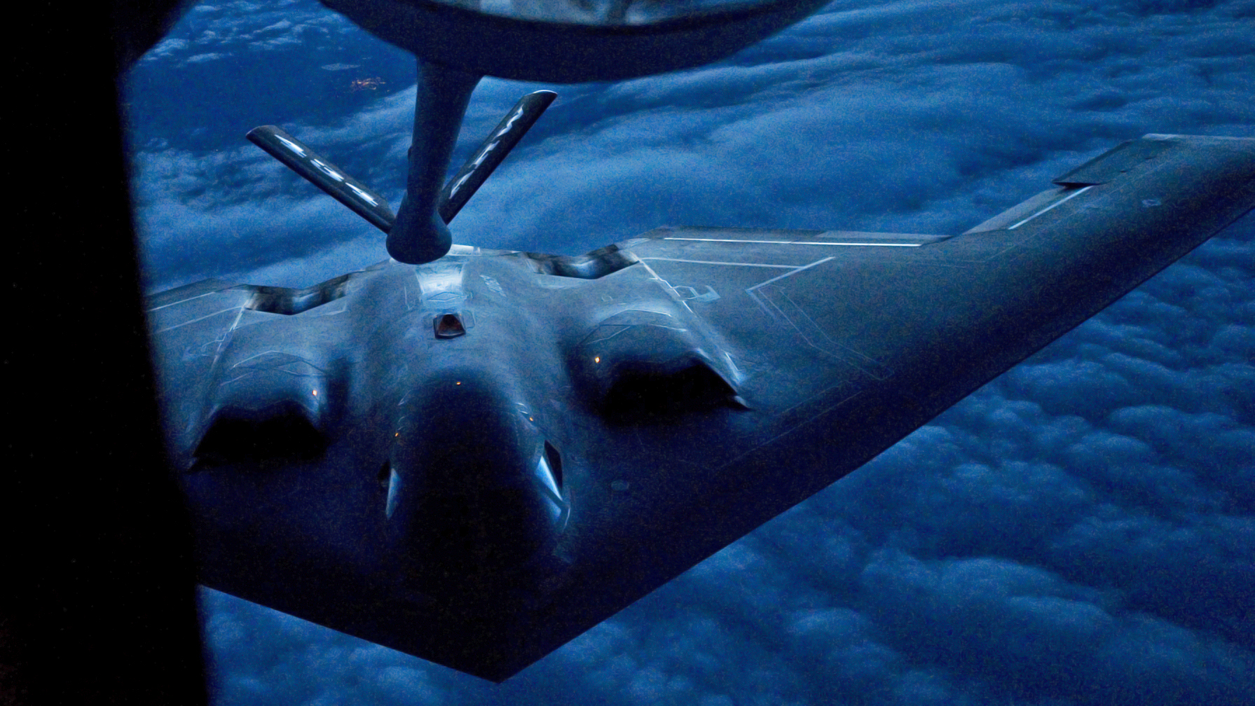 A B-2 Spirit from the 509th Bomb Wing, 13th Bomb Squadron Whiteman Air Force Base, Miss., prepares to be refueled by a KC-135R Stratotanker from the 434th Air Refueling Wing at Grissom Air Reserve Base, Ind. during a nighttime aerial refueling mission.