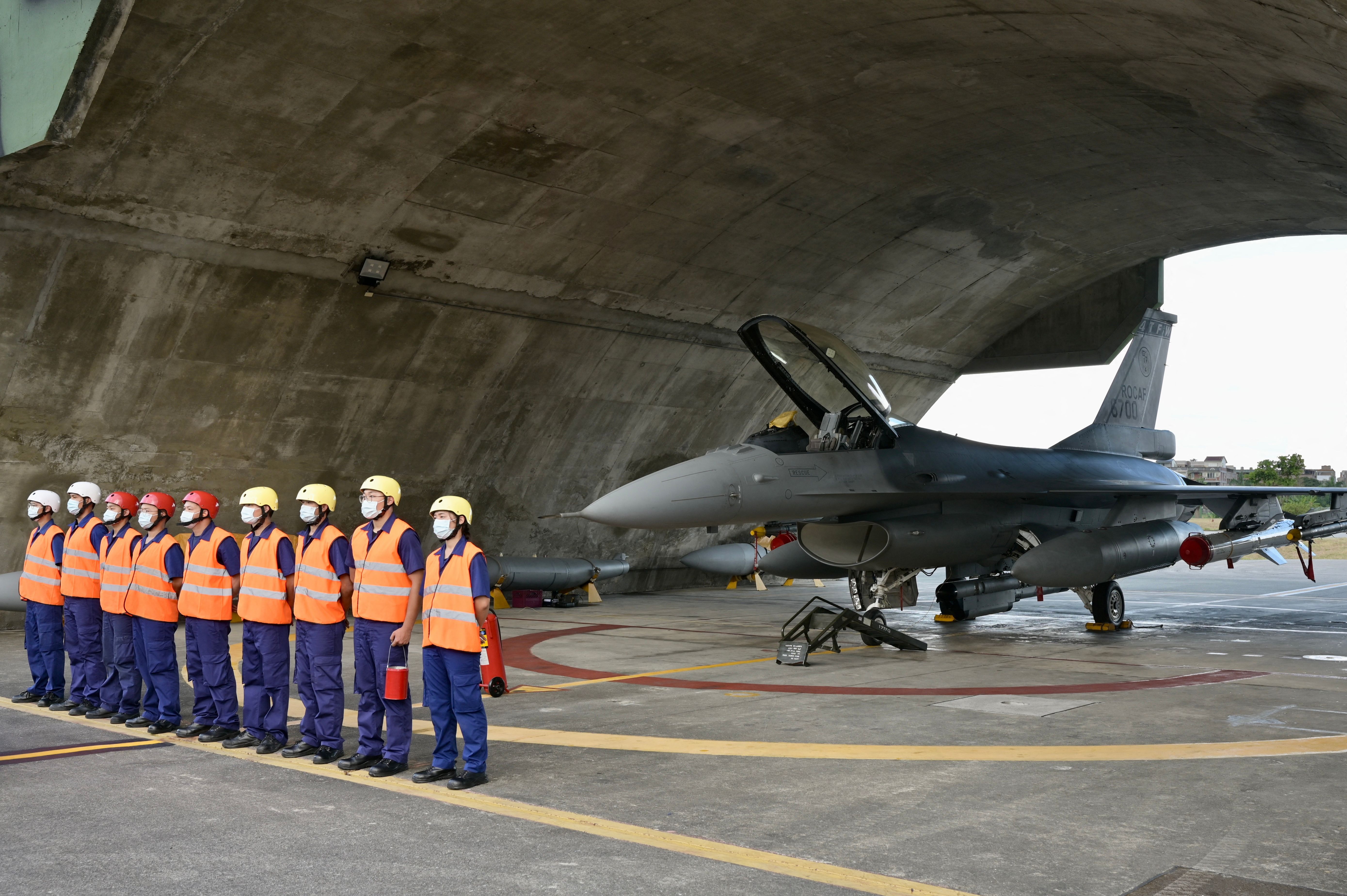 Air Force soldiers stand in front of an armed F-16V fighter jet during a drill at Hualien Air Force base on August 17, 2022. (Photo by Sam Yeh / AFP) (Photo by SAM YEH/AFP via Getty Images)