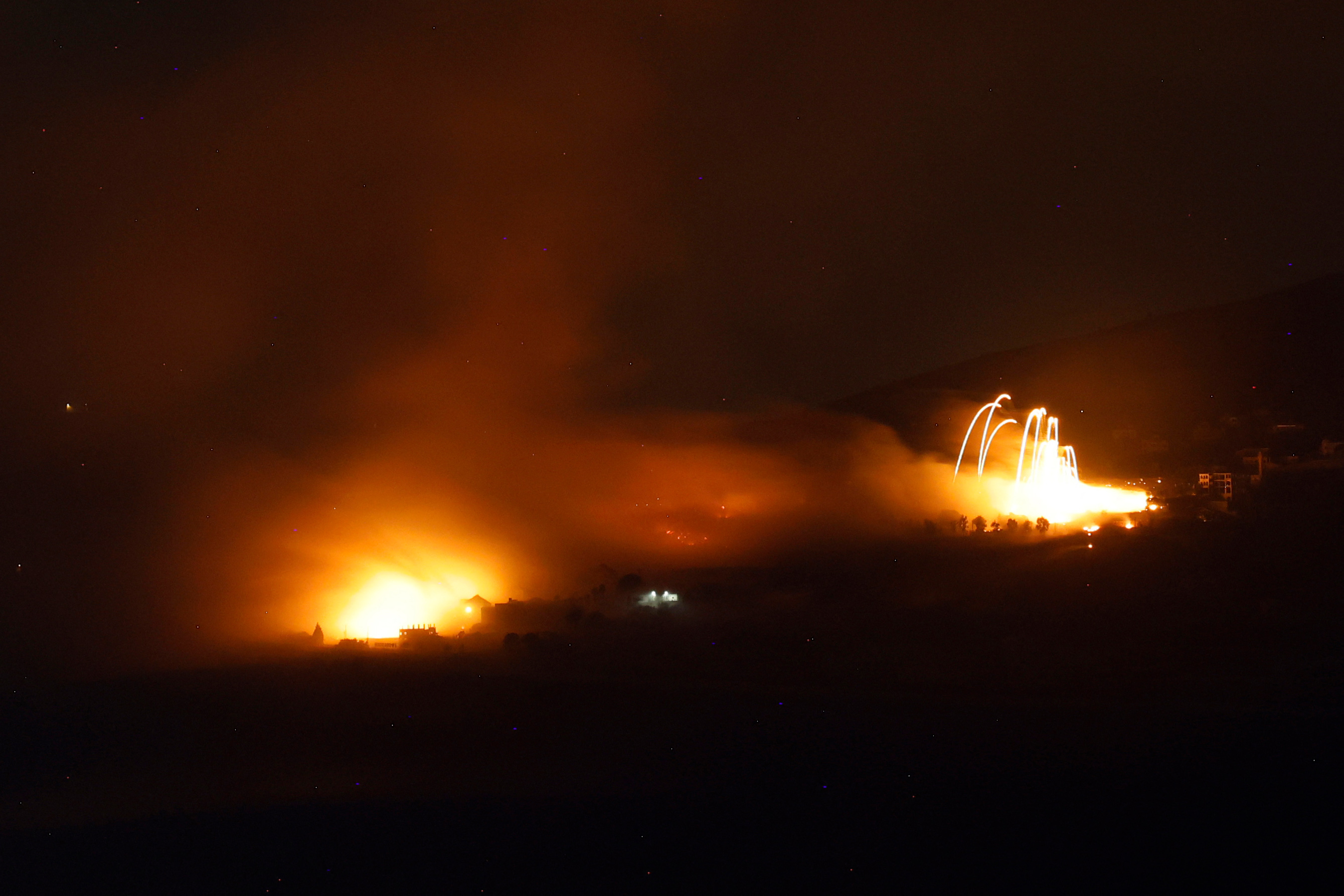 TOPSHOT - A picture taken from a position in Israel by the border with southern Lebanon shows a fire in the area of the Lebanese village of Adaisseh during Israeli bombardment on October 1, 2024. (Photo by Jalaa MAREY / AFP) (Photo by JALAA MAREY/AFP via Getty Images)