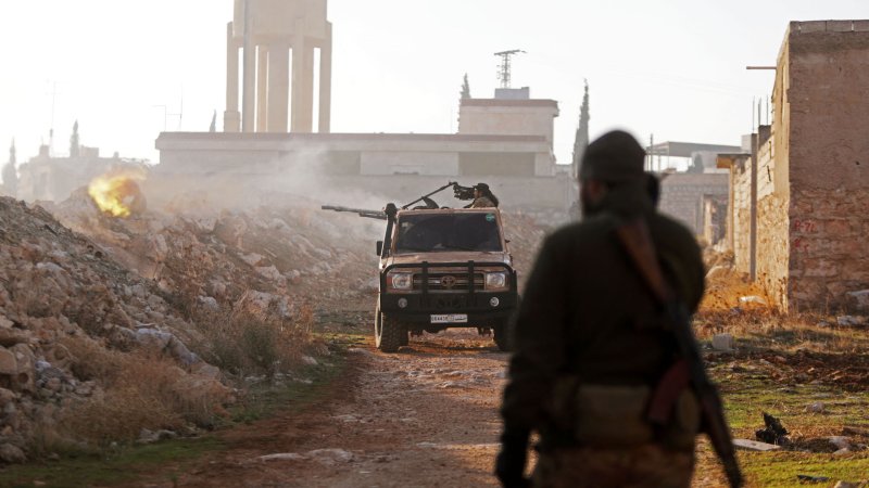 Fighters fire towards Syrian Army troops in the Rashidin district on the outskirts of Aleppo on November 29, 2024, as Hayat Tahrir al-Sham (HTS) jihadists and allied factions continue their offensive in the Aleppo province against government forces. The jihadists along with Turkey-backed factions launched this week a shock offensive against Syrian regime troops and sparked the deadliest battle the country has seen in years, with the violence killing so far 242 people, according to the Syrian Observatory for Human Rights. The war monitor said most of the victims were combatants on both sides but also including civilians.